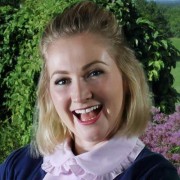 Broadly smiling woman with chin-length blonde hair